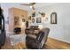 Cozy living room boasts wood floors, ceiling fan, and decorative wall art at 106 Baytree Blvd, Tavares, FL 32778