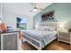 Relaxing main bedroom with a large window, light blue paint, and light-colored hardwood floors at 106 Baytree Blvd, Tavares, FL 32778