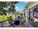 Brick patio with a fire pit, chairs, and lush landscaping at 106 Baytree Blvd, Tavares, FL 32778