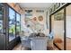 Cozy sunroom with fish-themed decor, a glass table and wicker chairs with blue cushions at 106 Baytree Blvd, Tavares, FL 32778
