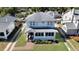 An aerial view of a well-maintained house featuring a brick walkway, mature trees and classic architecture at 1109 W Line St, Leesburg, FL 34748