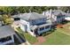 A view of a charming two-story home with mature landscaping and a brick walkway at 1109 W Line St, Leesburg, FL 34748