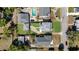 Aerial view of a property with a backyard pool and well-manicured lawn at 1109 W Line St, Leesburg, FL 34748