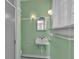 Bathroom featuring green tiling, shower and square sink beneath a bright window at 1109 W Line St, Leesburg, FL 34748