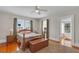 Comfortable bedroom with hardwood floors, ceiling fan, and multiple windows at 1109 W Line St, Leesburg, FL 34748