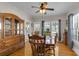 Classic dining room with a large china cabinet and wood furniture, filled with sunlight at 1109 W Line St, Leesburg, FL 34748