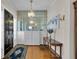 Inviting foyer with hardwood flooring, a chandelier, and a decorative console table at 1109 W Line St, Leesburg, FL 34748