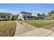 Charming house with a well-manicured front lawn, and long driveway at 1109 W Line St, Leesburg, FL 34748