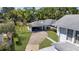 This aerial shot highlights the home's detached garage, long driveway, and well-manicured lawn at 1109 W Line St, Leesburg, FL 34748