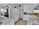 Bright kitchen with white cabinetry, modern appliances, and view to the dining room at 1109 W Line St, Leesburg, FL 34748