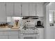 Efficient kitchen with white cabinets and modern appliances, offering plenty of storage at 1109 W Line St, Leesburg, FL 34748