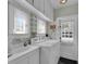 Well-lit laundry room with cabinetry and sink offers convenience at 1109 W Line St, Leesburg, FL 34748