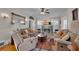 Bright living room with cozy seating, a fireplace, ceiling fan, and large decorative mirror at 1109 W Line St, Leesburg, FL 34748