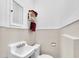 Compact powder room featuring a classic sink and toilet at 1109 W Line St, Leesburg, FL 34748