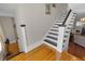 Staircase with black and white risers and hardwood landing at 1109 W Line St, Leesburg, FL 34748