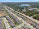 Birds eye view of a neatly planned neighborhood with winding streets, picturesque pond, and rows of lovely homes at 1128 Cavender Creek Rd, Minneola, FL 34715