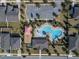 Aerial view of community pool, playground, parking, and neighborhood homes at 1128 Cavender Creek Rd, Minneola, FL 34715