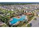Overhead view of community featuring pool, surrounded by residential properties and green landscaping at 1128 Cavender Creek Rd, Minneola, FL 34715