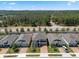 Aerial view of a two-story home featuring a brick driveway and a well-maintained front lawn and landscaping at 1128 Cavender Creek Rd, Minneola, FL 34715