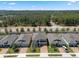 Aerial view of a two-story home featuring a brick driveway and a well-maintained front lawn and landscaping at 1128 Cavender Creek Rd, Minneola, FL 34715