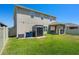 View of the backyard, showcasing a covered patio, storage shed, and well-maintained lawn at 1128 Cavender Creek Rd, Minneola, FL 34715