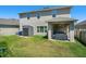 Backyard featuring a storage shed, lawn, and covered patio with an outdoor grill at 1128 Cavender Creek Rd, Minneola, FL 34715