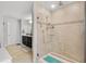 Modern bathroom with glass shower, tiled walls, and double sink vanity at 1128 Cavender Creek Rd, Minneola, FL 34715