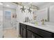 Stylish bathroom featuring double vanity with modern fixtures and coastal decor at 1128 Cavender Creek Rd, Minneola, FL 34715