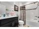 Bathroom features a shower-tub combination, decorative shower curtain, and modern vanity at 1128 Cavender Creek Rd, Minneola, FL 34715