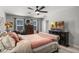 Spacious bedroom with ceiling fan, large window, dresser, and a comfortable bed at 1128 Cavender Creek Rd, Minneola, FL 34715