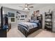Inviting bedroom with blue accents, built-in shelves, and natural light from the window at 1128 Cavender Creek Rd, Minneola, FL 34715