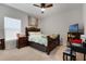 Cozy bedroom with wood furniture, ceiling fan, and natural light from the window at 1128 Cavender Creek Rd, Minneola, FL 34715