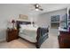 Comfortable bedroom featuring a traditional wood bed frame, side tables, and serene decor at 1128 Cavender Creek Rd, Minneola, FL 34715