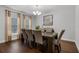 Formal dining room with modern chandelier, large window, and neutral decor at 1128 Cavender Creek Rd, Minneola, FL 34715