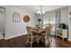 Dining area features wood floors, natural light, and modern farmhouse decor at 1128 Cavender Creek Rd, Minneola, FL 34715