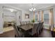 Bright dining room features a large dining table, wood floors, and elegant chandelier at 1128 Cavender Creek Rd, Minneola, FL 34715