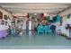 Spacious garage featuring epoxy flooring, ample storage, and organized recreational equipment at 1128 Cavender Creek Rd, Minneola, FL 34715