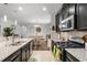 Open kitchen with granite countertops, stainless appliances, and access to the dining area at 1128 Cavender Creek Rd, Minneola, FL 34715