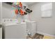 Functional laundry room with washer, dryer, and shelving for storage at 1128 Cavender Creek Rd, Minneola, FL 34715