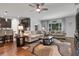 Open-concept living room combines seating and kitchen area with dark cabinetry and granite countertops at 1128 Cavender Creek Rd, Minneola, FL 34715