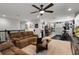 Expansive living room with comfortable seating, an entertainment area, and fitness equipment at 1128 Cavender Creek Rd, Minneola, FL 34715