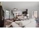 Spacious living room featuring hardwood floors, abundant natural light, and comfortable seating at 1128 Cavender Creek Rd, Minneola, FL 34715