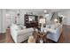 Bright living room features hardwood floors, neutral paint, and large built-in entertainment center at 1128 Cavender Creek Rd, Minneola, FL 34715