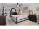 Comfortable main bedroom with upholstered headboard, wood furniture, and serene decor at 1128 Cavender Creek Rd, Minneola, FL 34715
