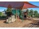 Community playground with slides, climbing structures and protective awning at 1128 Cavender Creek Rd, Minneola, FL 34715