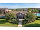The pool entrance with a walkway is lined with manicured shrubbery and vibrant flowering bushes at 1128 Cavender Creek Rd, Minneola, FL 34715