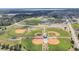 Aerial view showcasing the community's sports complex, featuring baseball fields and open green spaces at 1281 Gatewood Ave, Minneola, FL 34715