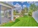 Inviting backyard with artificial turf, patio, screened-in porch, and well-maintained landscaping at 1281 Gatewood Ave, Minneola, FL 34715