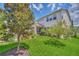 Expansive backyard showcasing lush green lawn, mature trees, and a screened-in porch for outdoor living at 1281 Gatewood Ave, Minneola, FL 34715