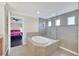 Luxurious bathroom with soaking tub and glass-enclosed shower featuring stylish tile work at 1281 Gatewood Ave, Minneola, FL 34715
